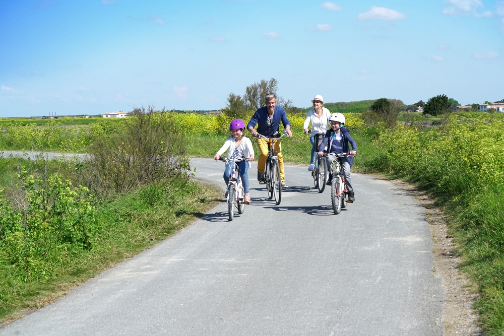 Happy,Family,Riding,Bikes,On,Week-end,In,Countryside